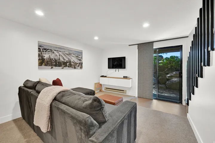 Living room area of the basement with access to patio on main level of the community grounds.