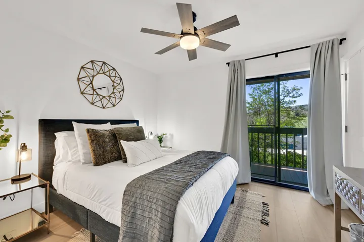 Main floor bedroom #1 with LVP flooring and a private deck.