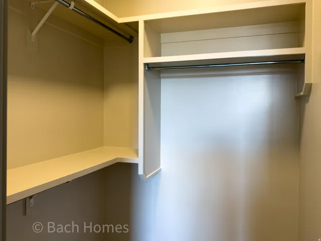 Built-in shelving, multiple hanging rods, and ample storage space