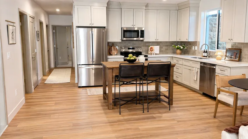Kitchen featuring stainless steel appliances, white cabinets, backsplash, recessed lighting, and light wood-style floors