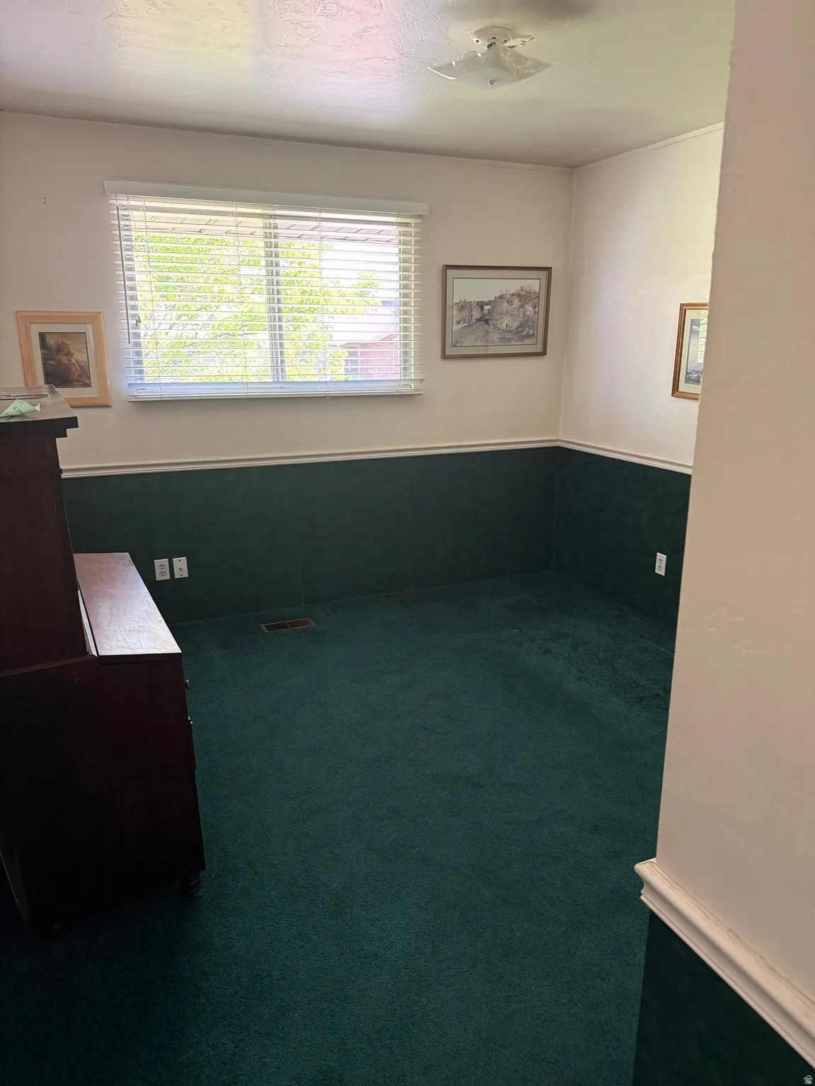 Unfurnished office with dark carpet