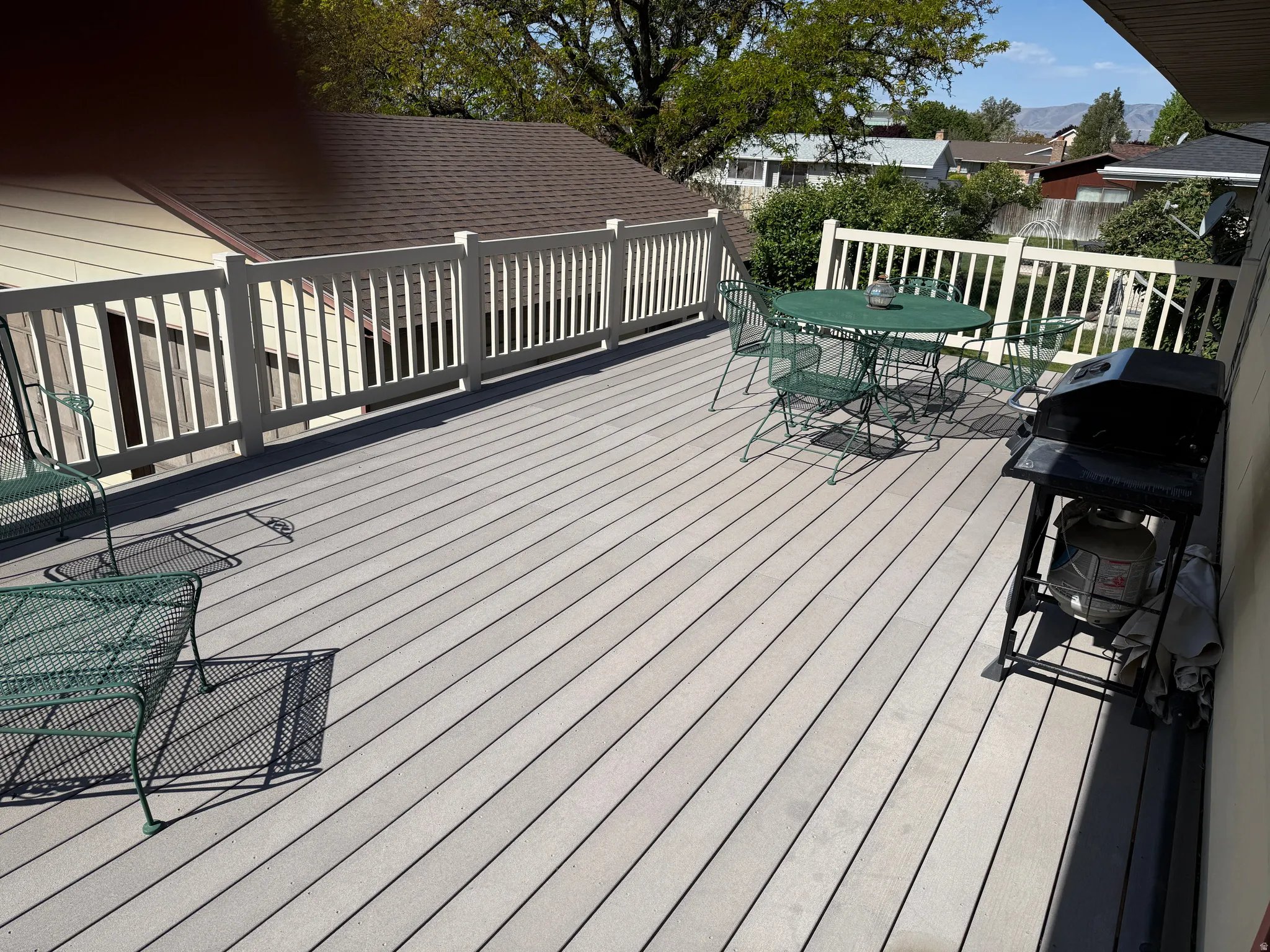 Wooden deck with area for grilling and outdoor dining space