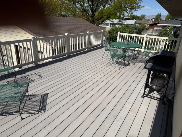 Wooden deck with area for grilling and outdoor dining space