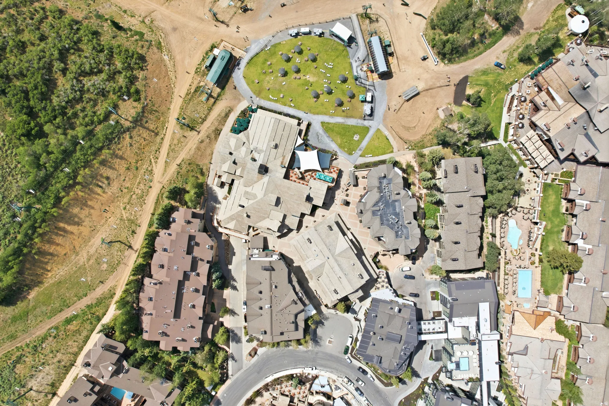 Aerial perspective showcasing multiple properties with varied rooflines and architectural styles