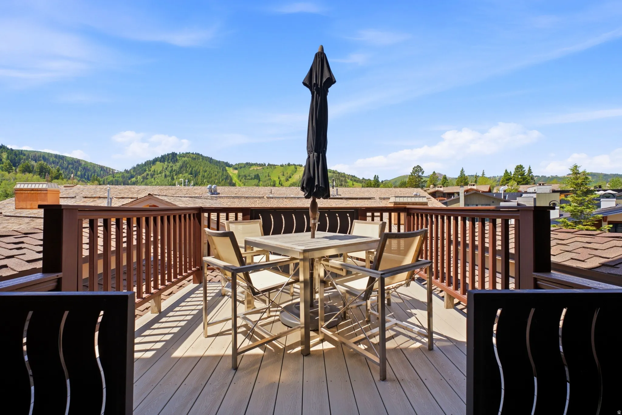 Rooftop deck featuring composite decking and a sturdy wood railing