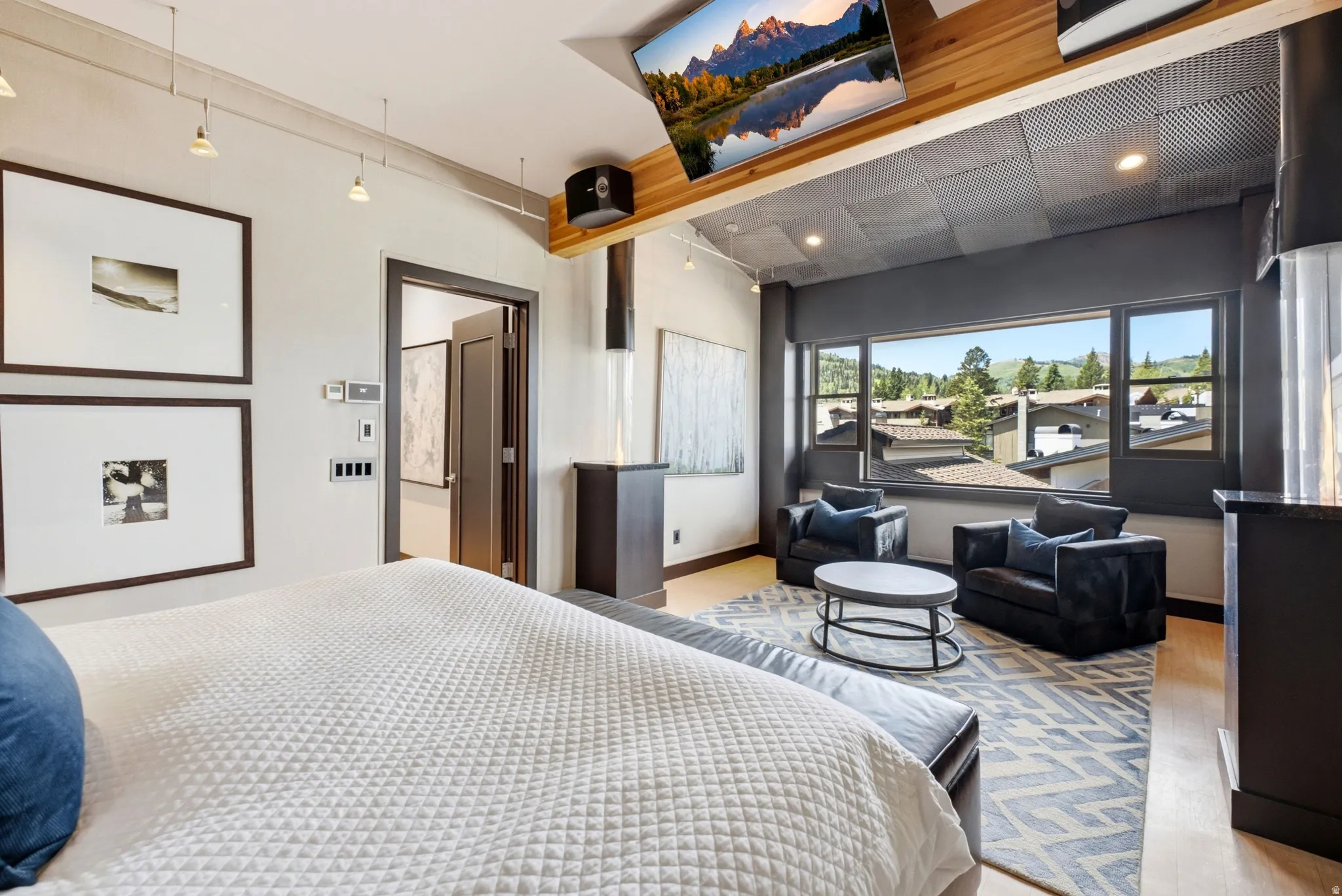 Expansive room featuring light wood-finish flooring and a distinctive ceiling design