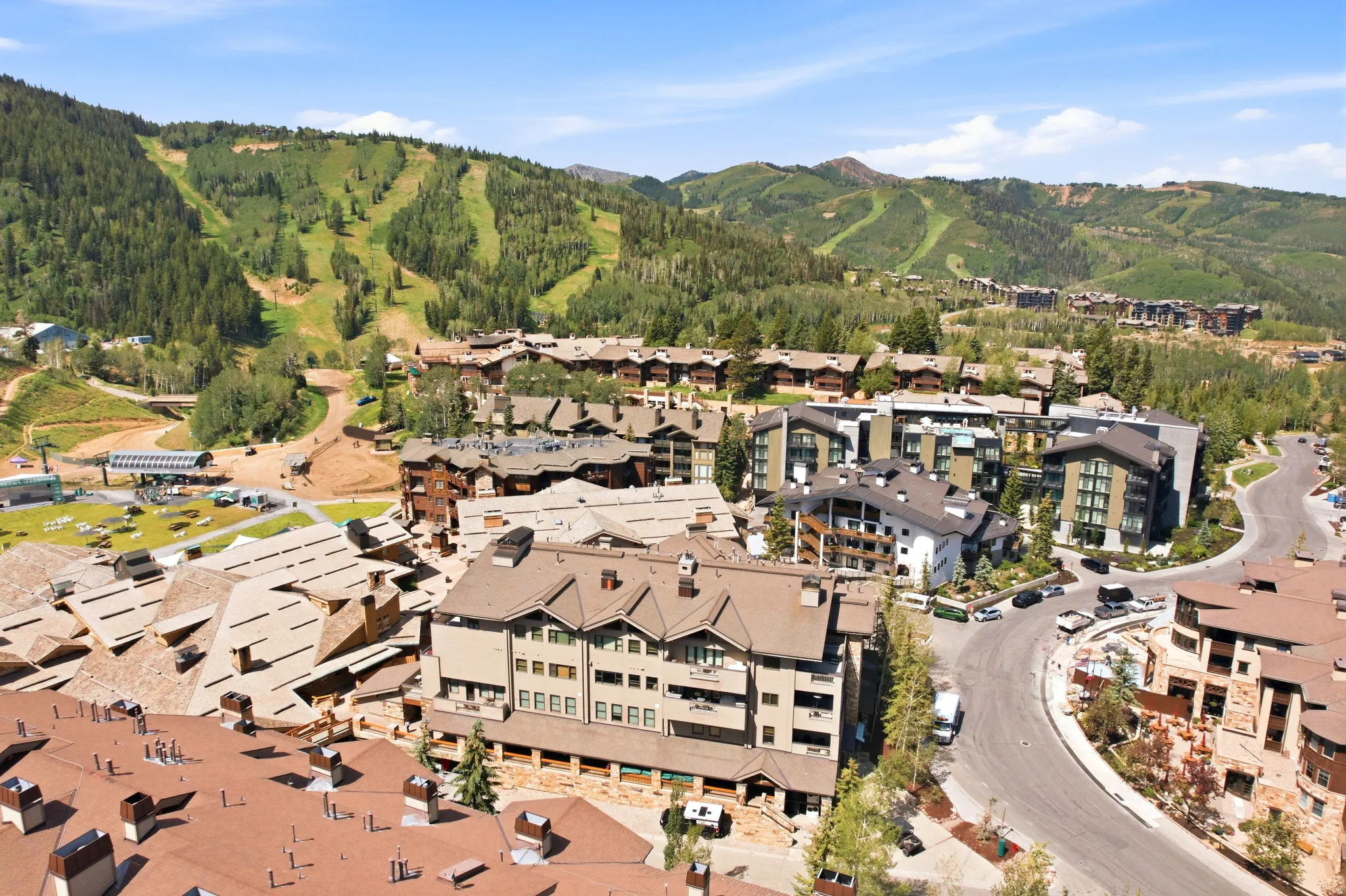 Mountain resort community featuring multiple residential buildings with varied architectural styles, including stone and wood-clad facades