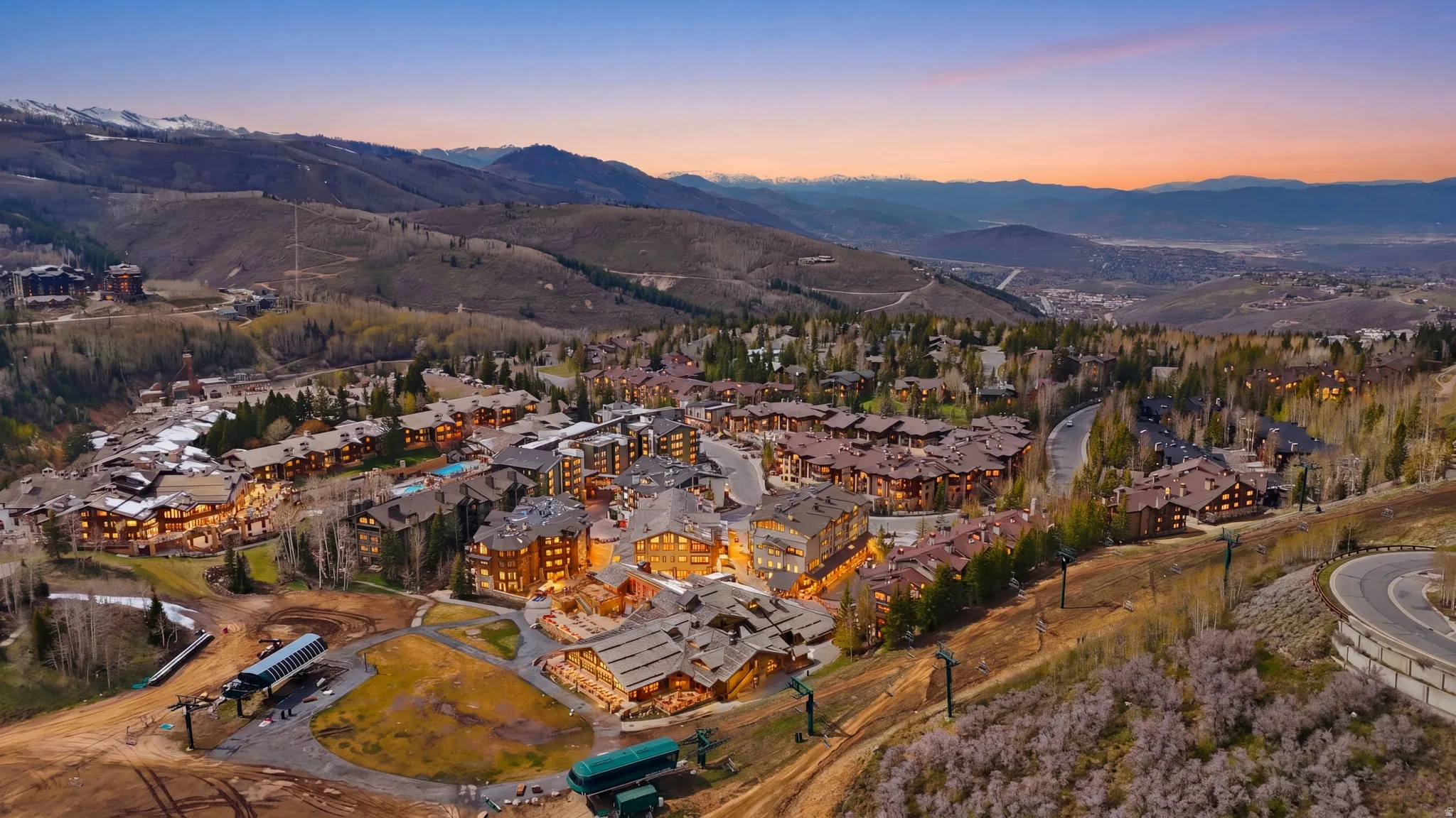 Expansive mountain resort community featuring multiple residences, commercial structures, and a winding road