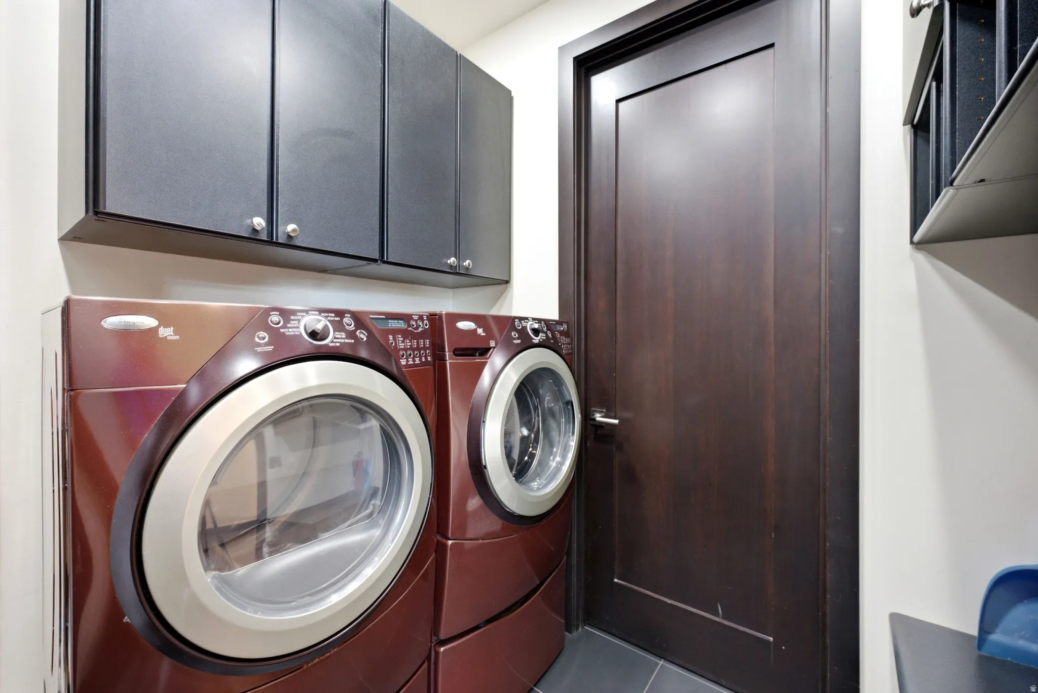 Dedicated laundry area featuring front-loading washer and dryer units
