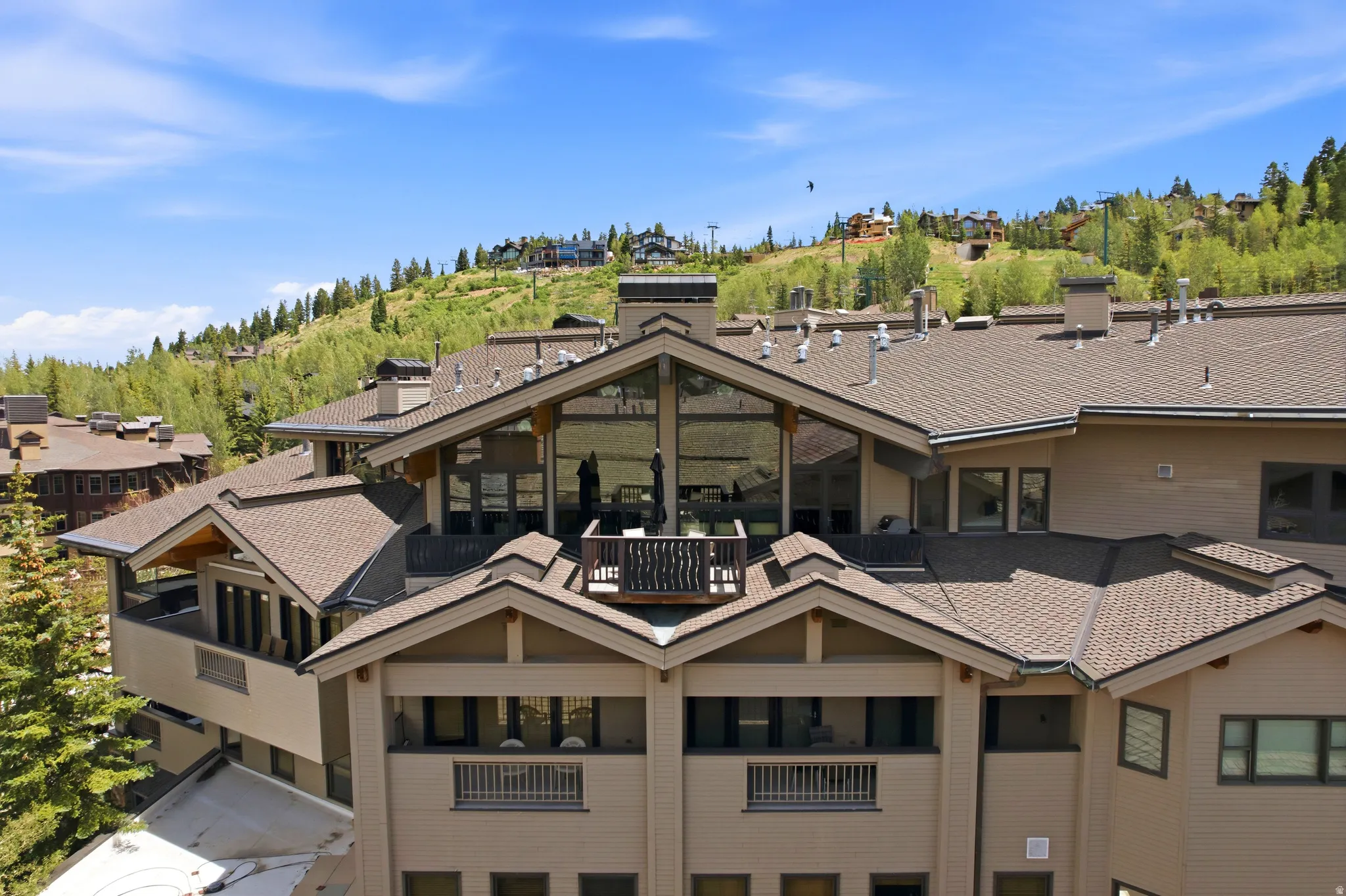 Multi-level building with pitched roofs and multiple balconies