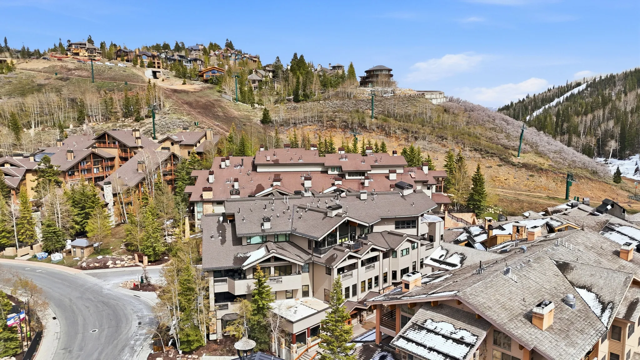 Mountain community featuring multiple residences with pitched roofs and natural wood and stone exteriors