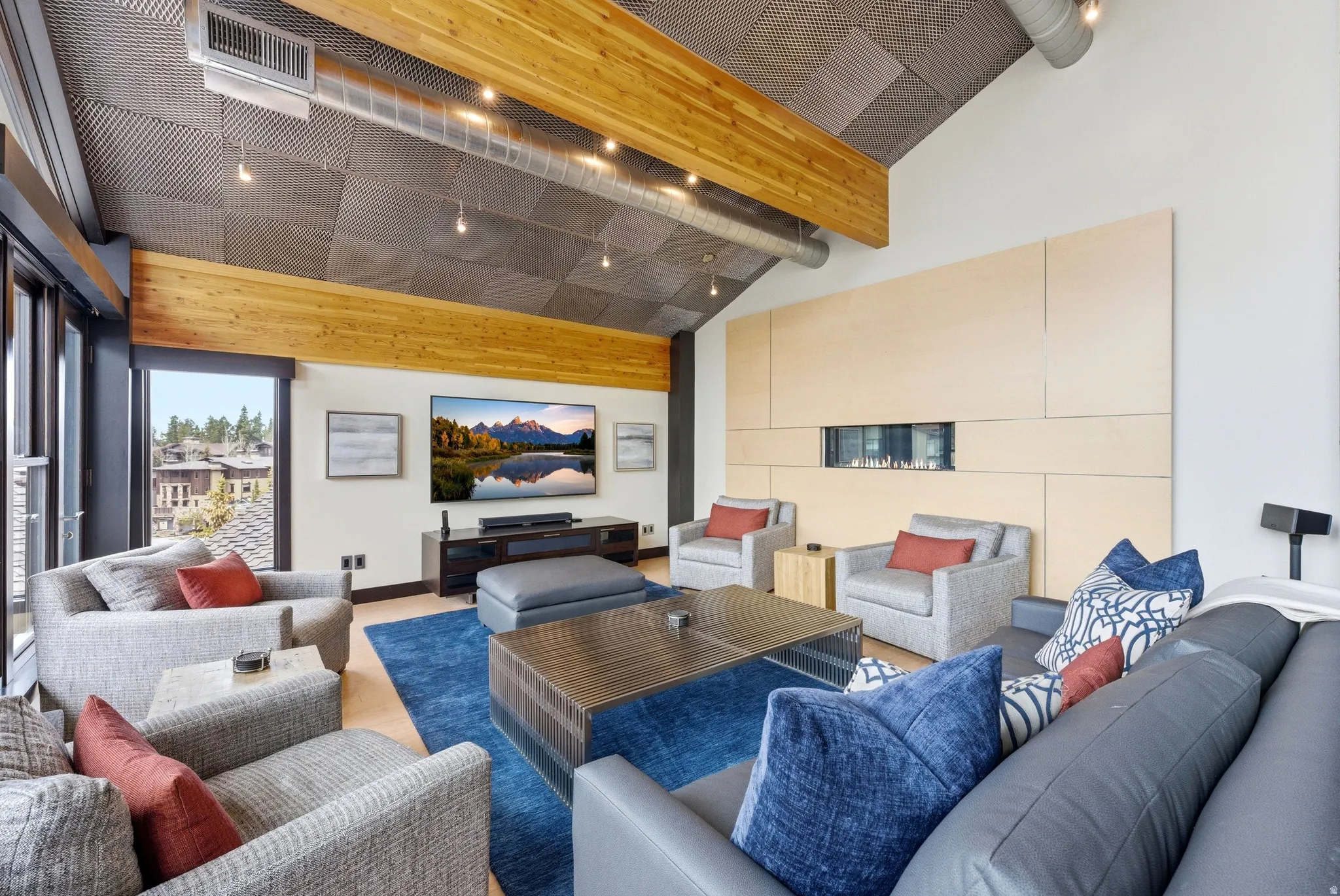 Vaulted ceiling with exposed wood beams and industrial-style ductwork
