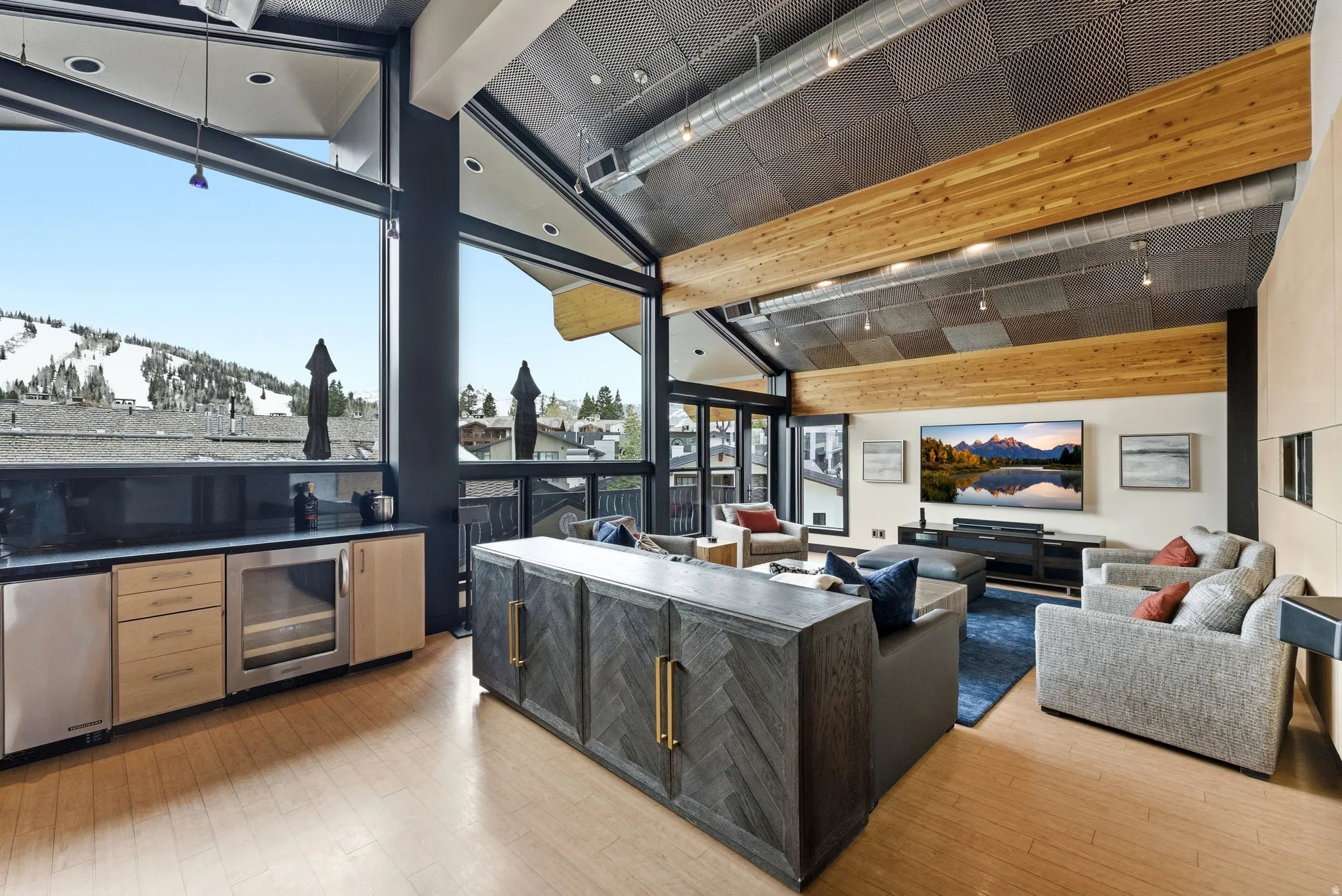 Vaulted ceiling with exposed wood beams and architectural lighting
