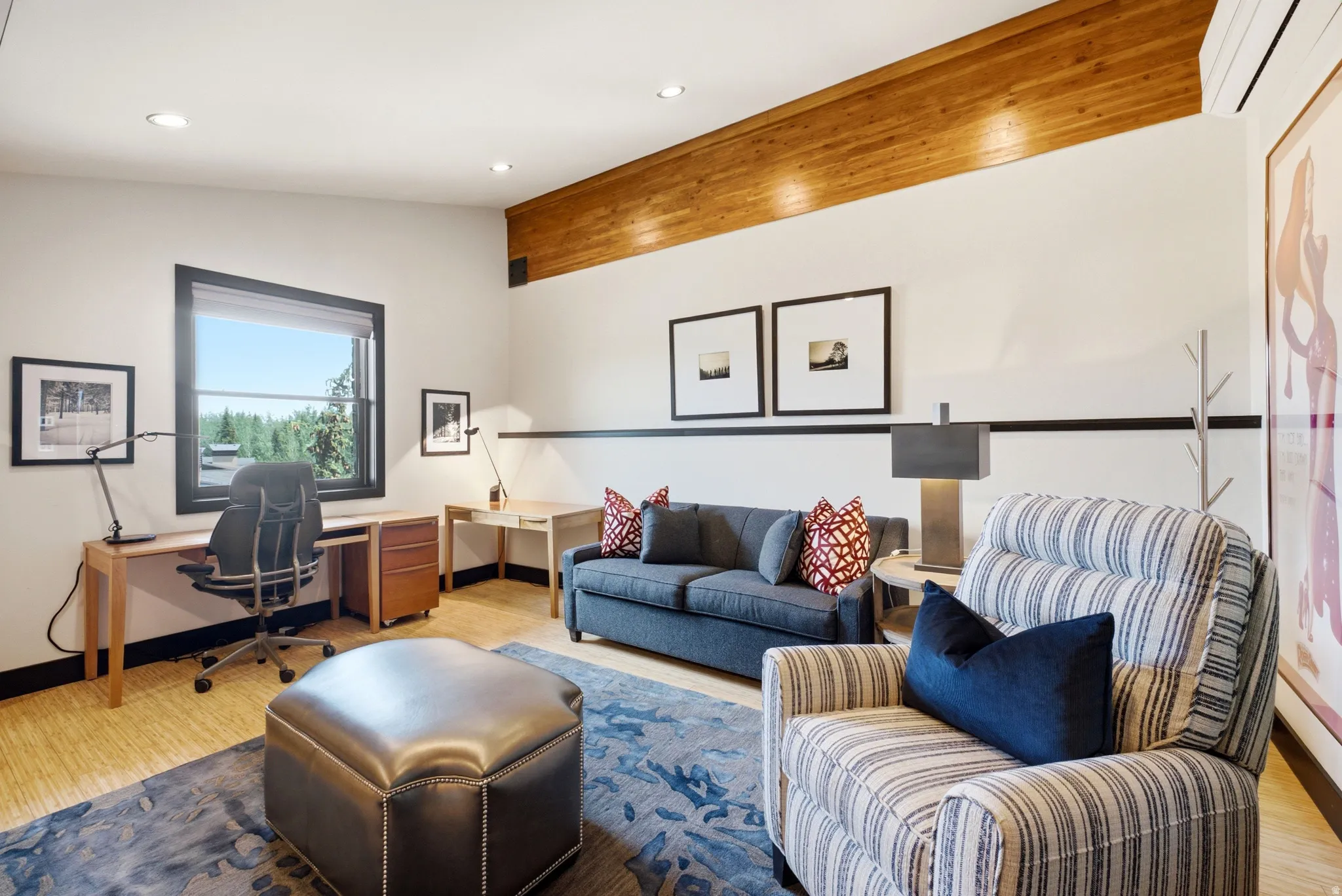 Bright room featuring recessed lighting, a prominent wood beam ceiling accent, and light wood-finish flooring