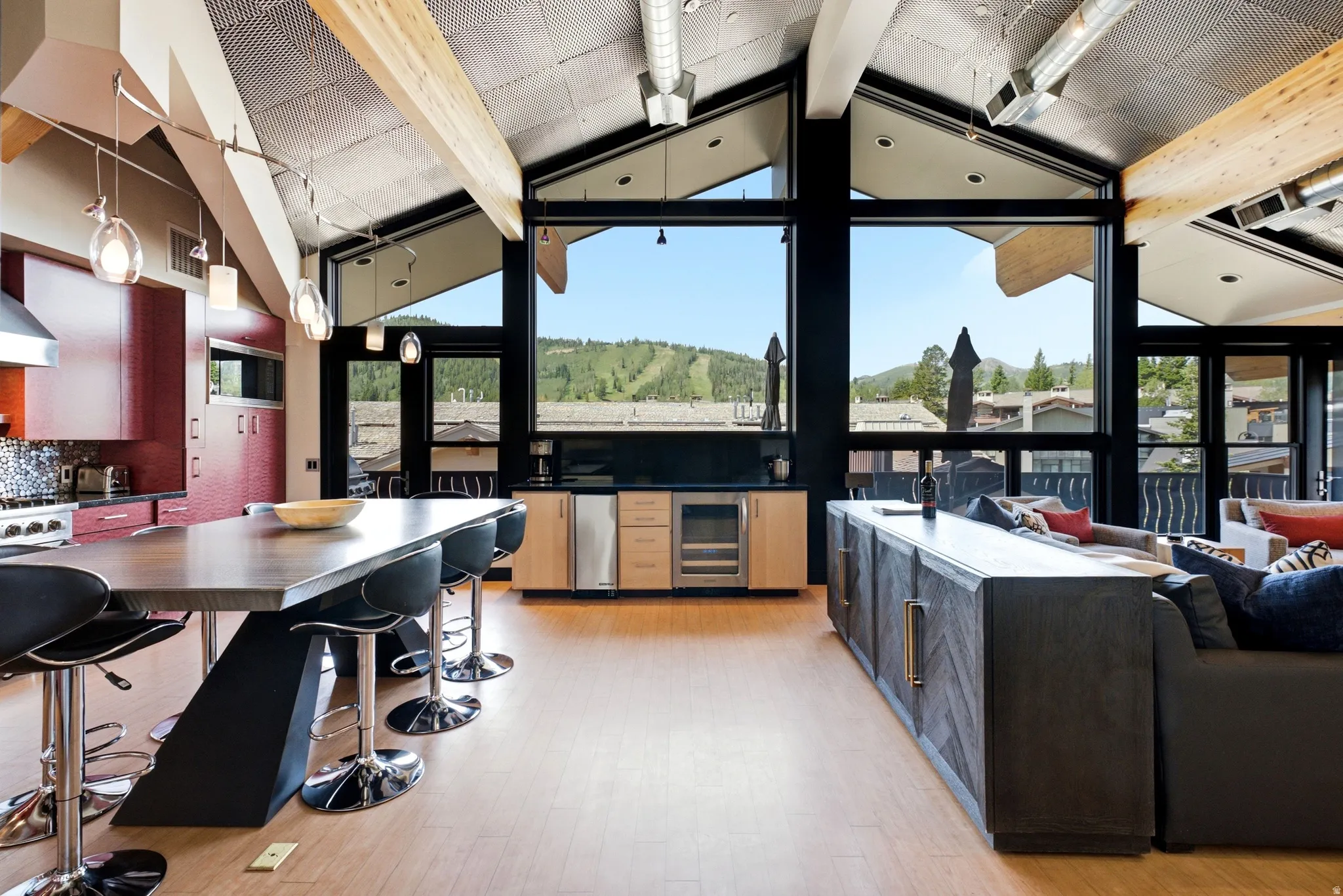 Vaulted ceilings with exposed wood beams and track lighting