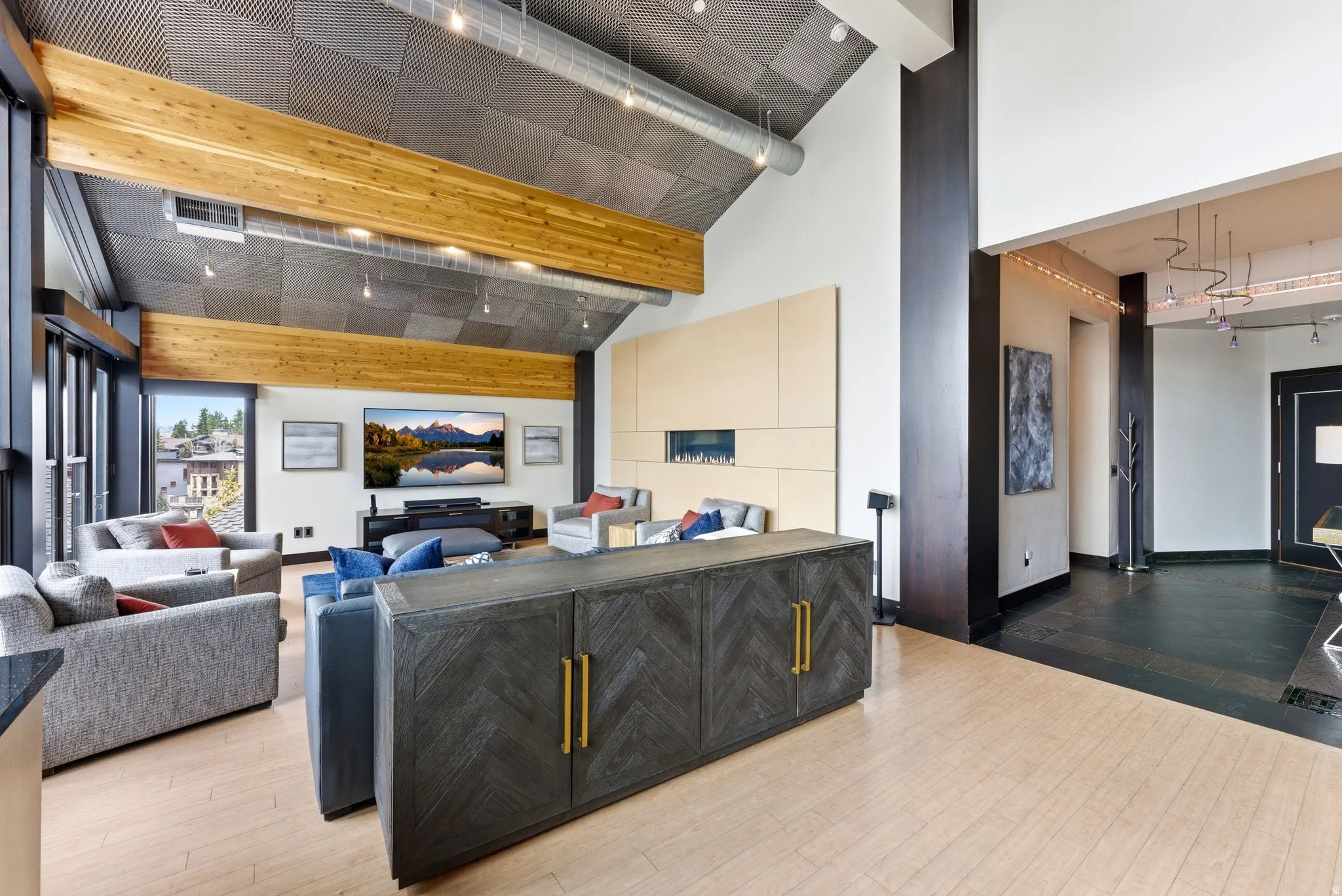 Vaulted ceiling with exposed wood beams and industrial-style ductwork