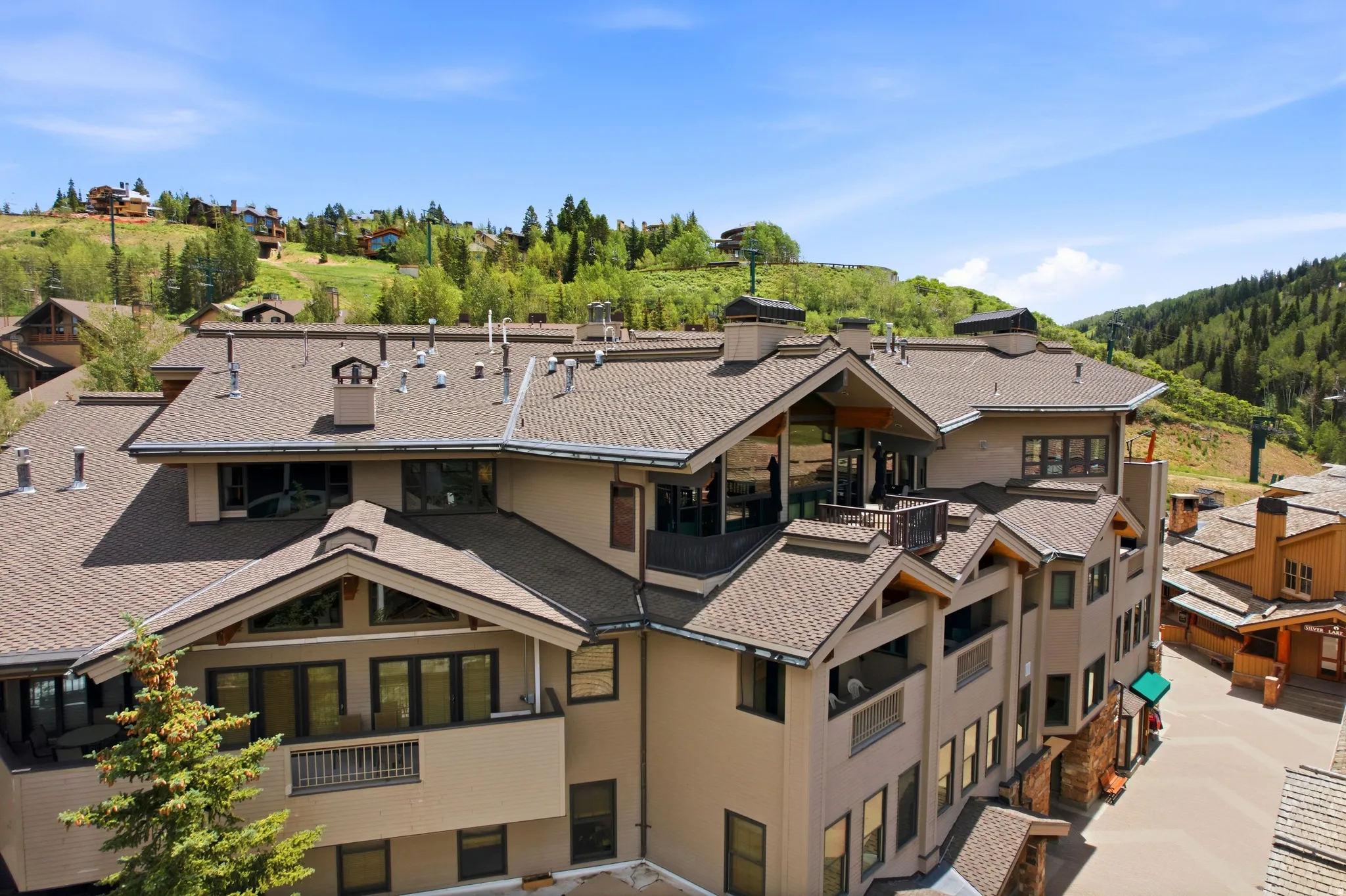 Multi-story residential structure featuring multiple balconies and a pitched shingle roof