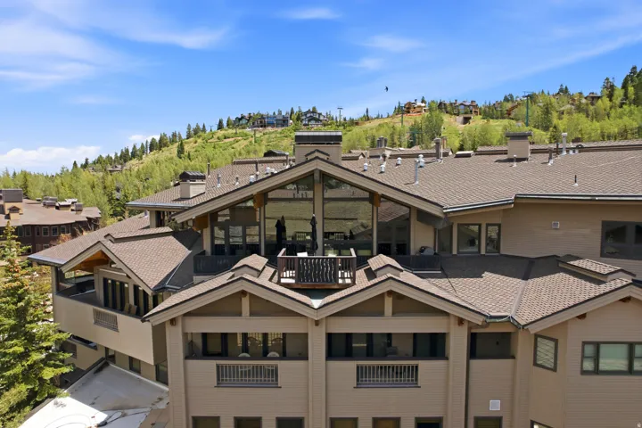 Multi-level building with pitched roofs and multiple balconies