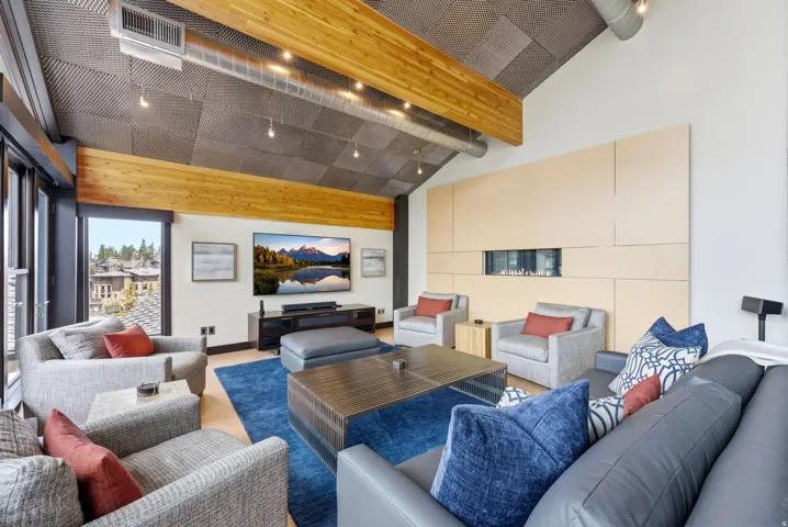 Vaulted ceiling with exposed wood beams and industrial-style ductwork