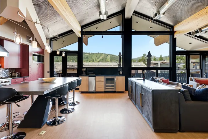 Vaulted ceilings with exposed wood beams and track lighting