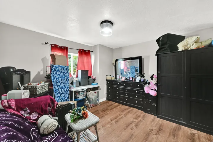 Bedroom featuring light wood finished floors and a textured ceiling