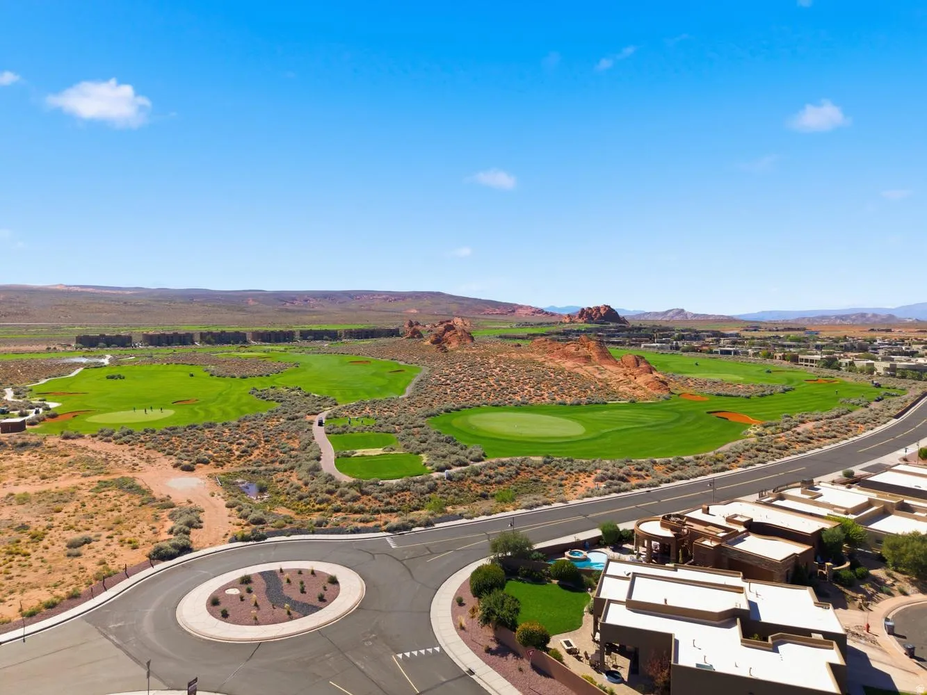 Drone / aerial view of mountains and a local golf course