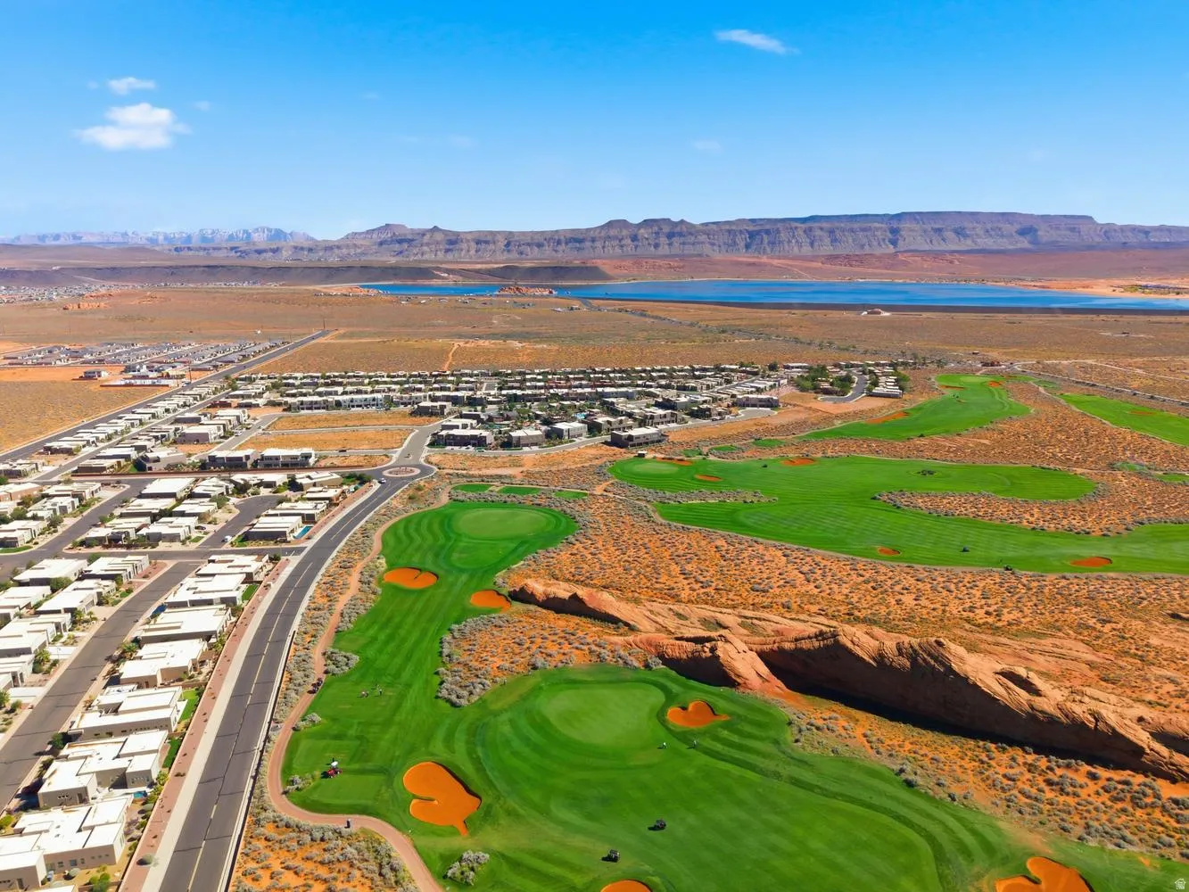 Aerial perspective of suburban area featuring a water and mountain view and a golf course