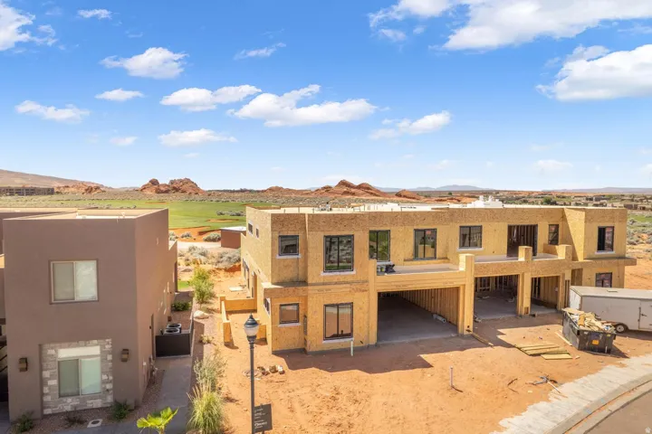 View of front of property featuring a mountain view, stucco siding, and a patio