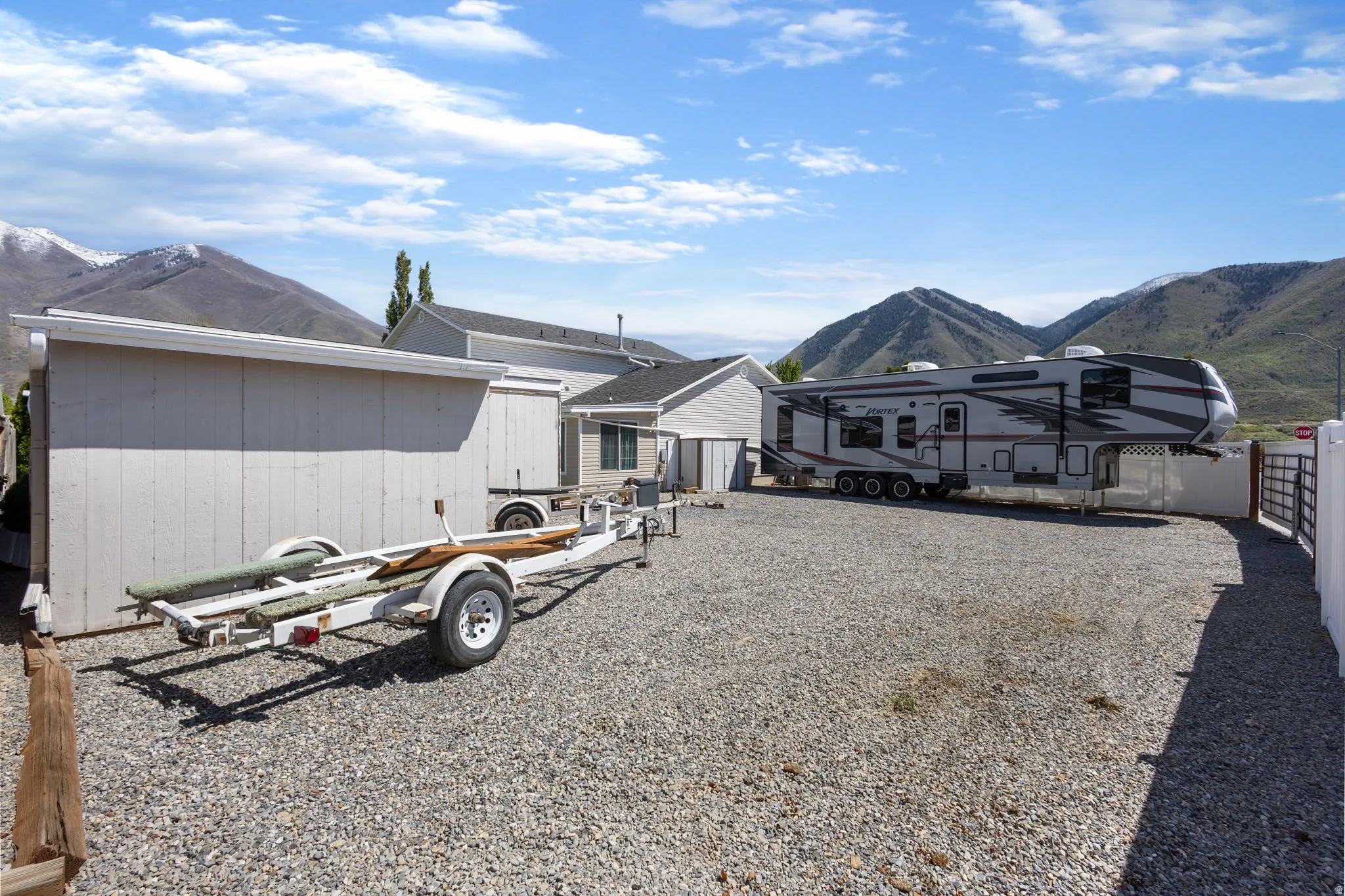 Rear view of house with a mountain view and an outbuilding
