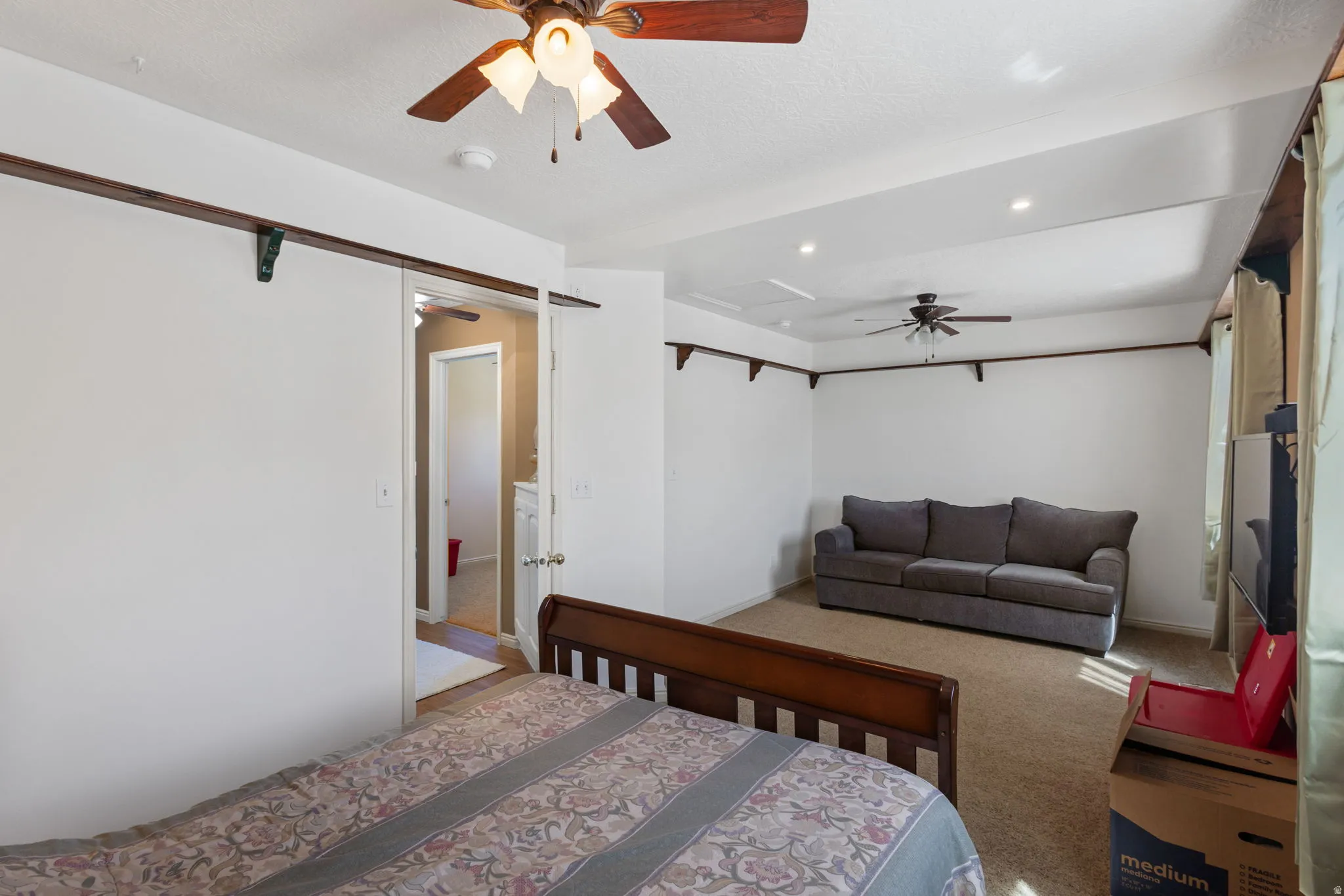 Bedroom with light carpet, recessed lighting, and a ceiling fan