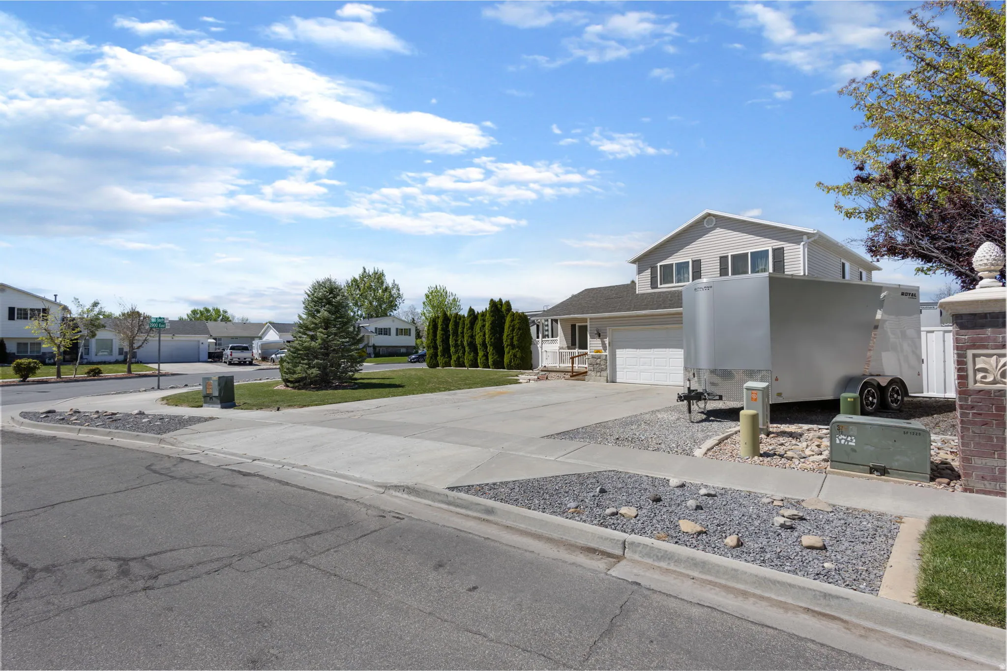 Traditional-style home with concrete driveway, a residential view, stone siding, and a garage