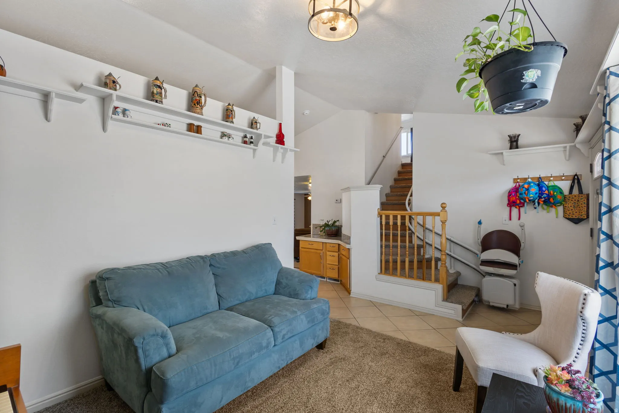 Living room with lofted ceiling and light tile patterned flooring