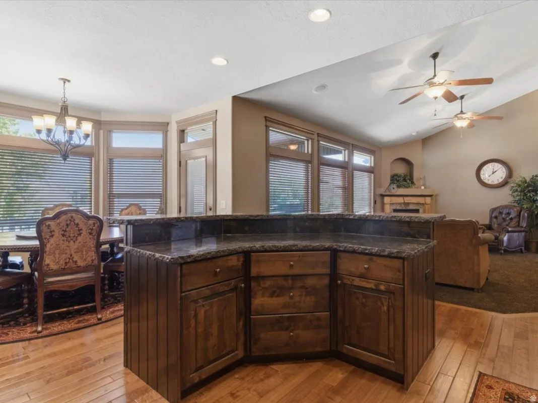 Central kitchen island with dark wood cabinetry and stone-finish countertop