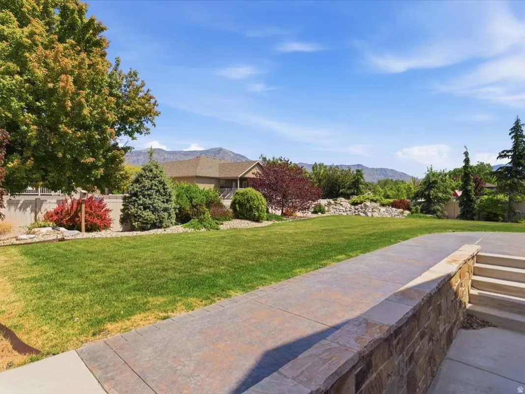 Expansive lawn with mature trees and diverse landscaping