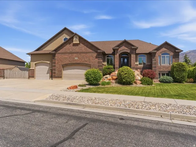 Brick and stucco facade with arched entry and multiple window styles