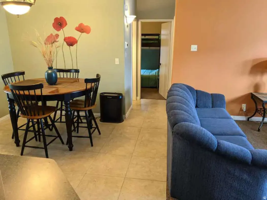 Dining space featuring light tile patterned floors and baseboards