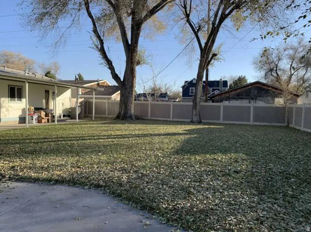 Fenced backyard featuring a patio