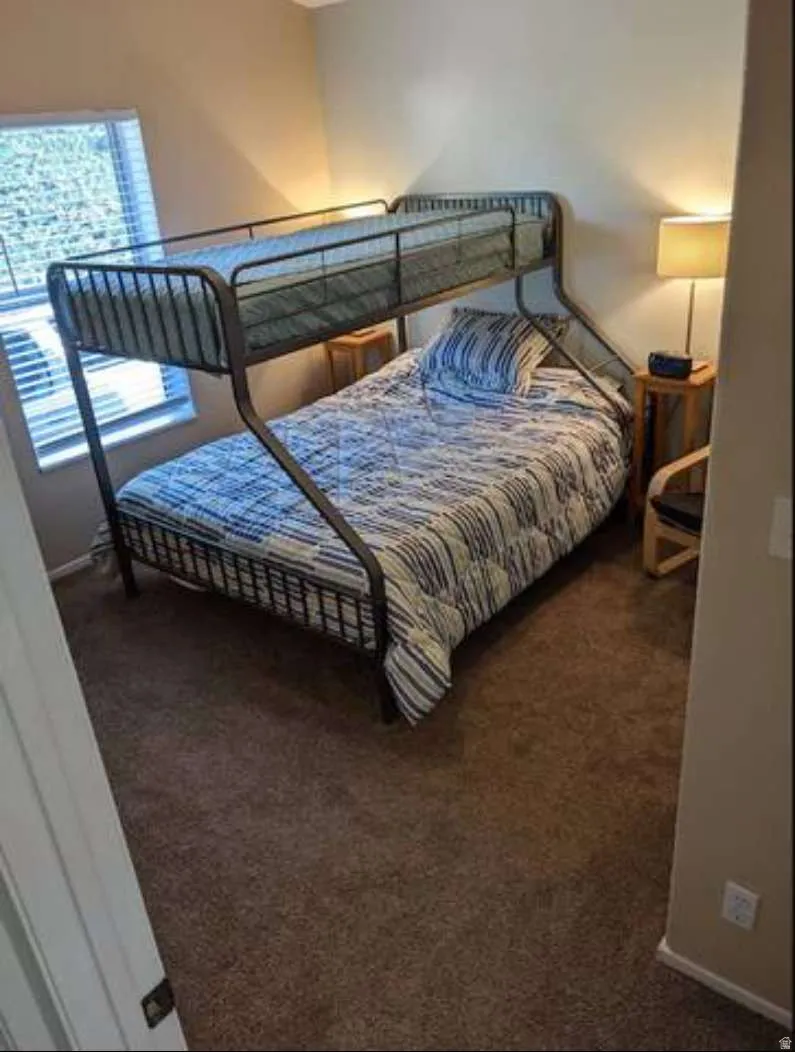 Carpeted bedroom with baseboards