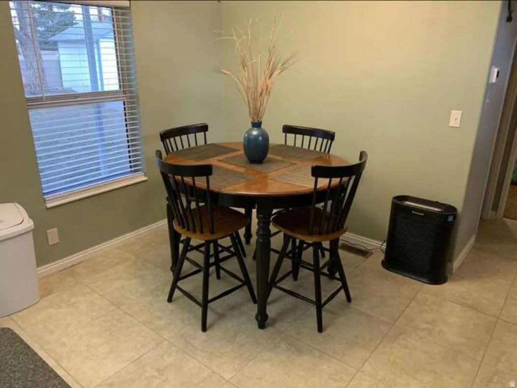 Dining area with light tile patterned flooring