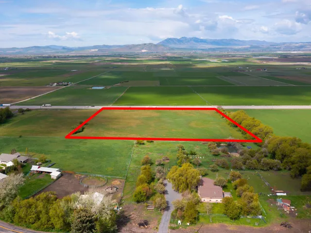 Overview of rural landscape featuring a mountain backdrop and property parcel outlined