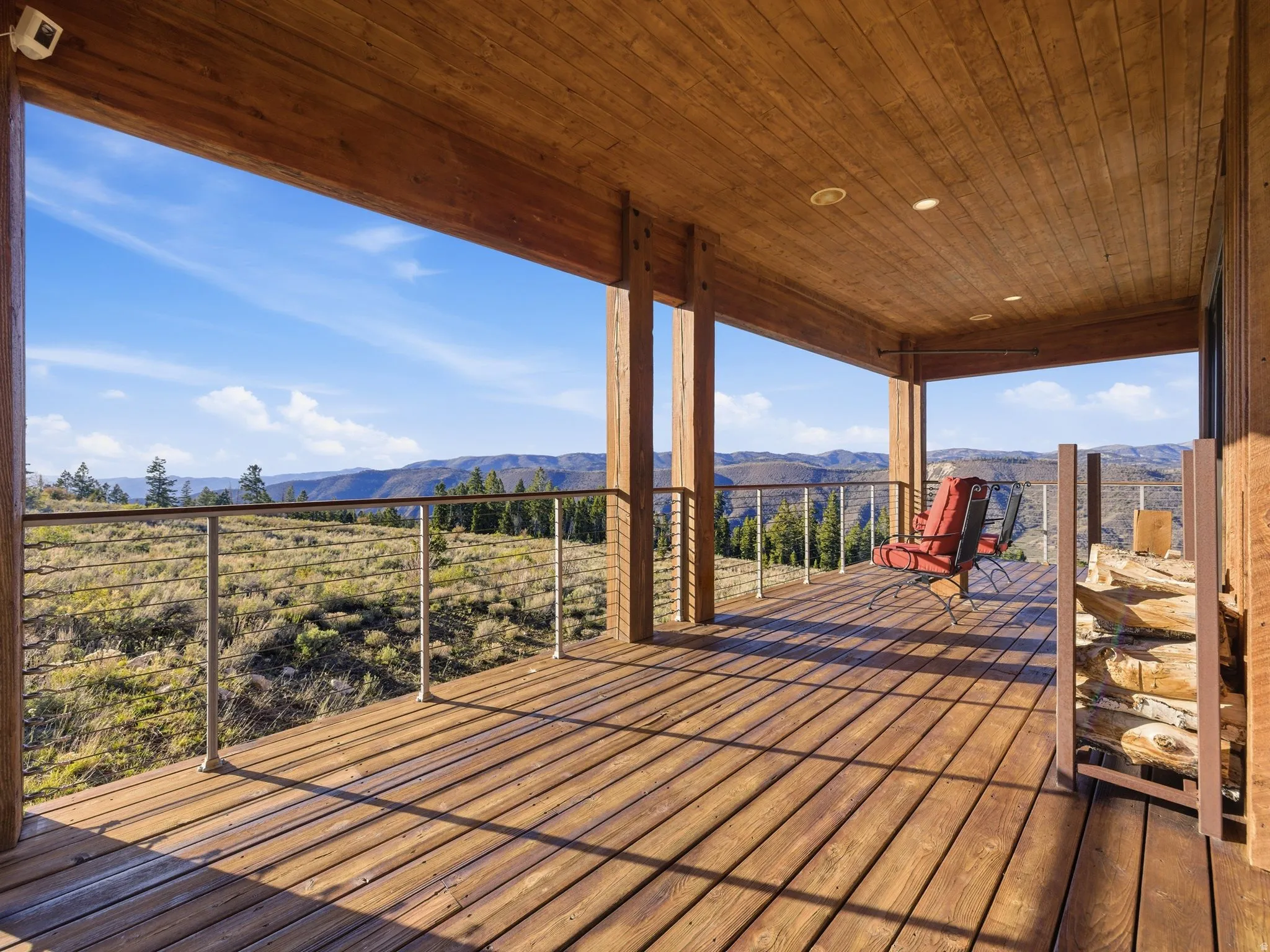 Wooden deck featuring a patio and a mountain view