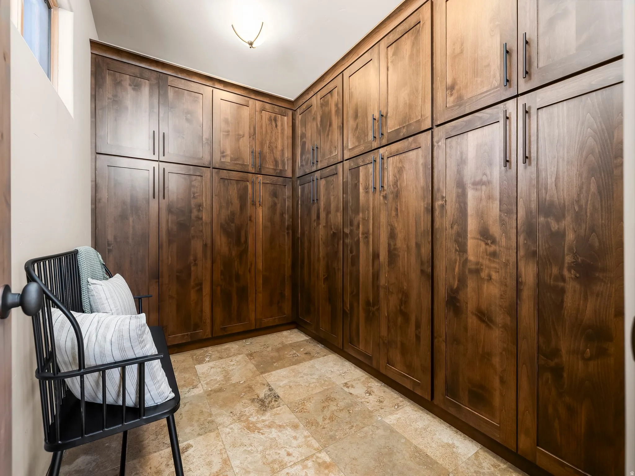 Mudroom featuring light stone finish flooring