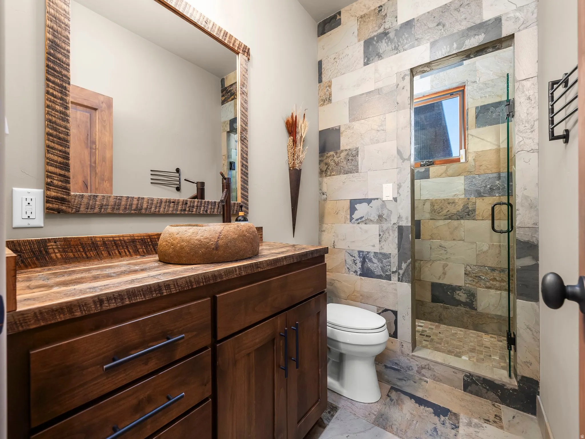 Bathroom with a shower stall and vanity