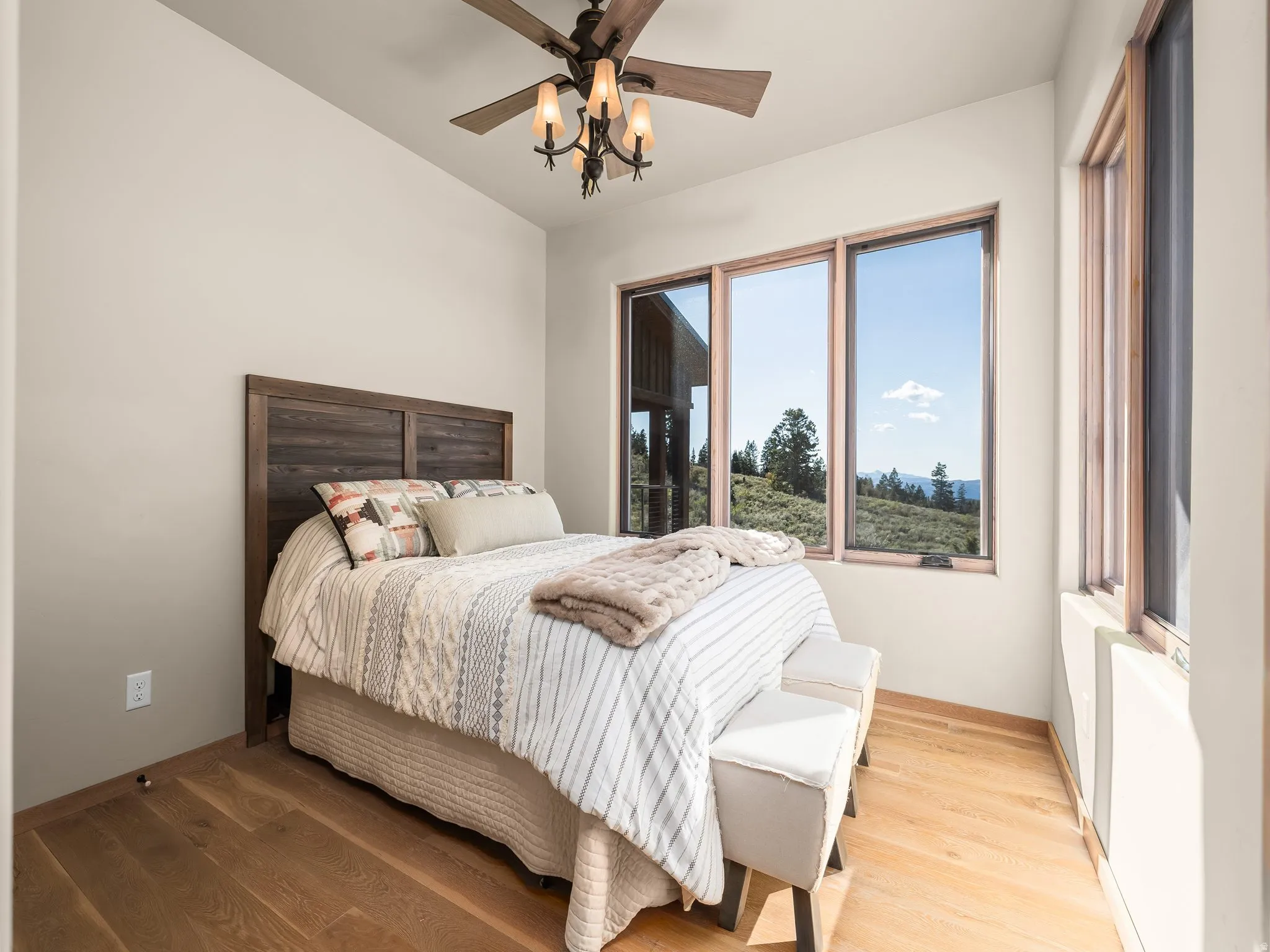 Bedroom featuring wood finished floors and a ceiling fan