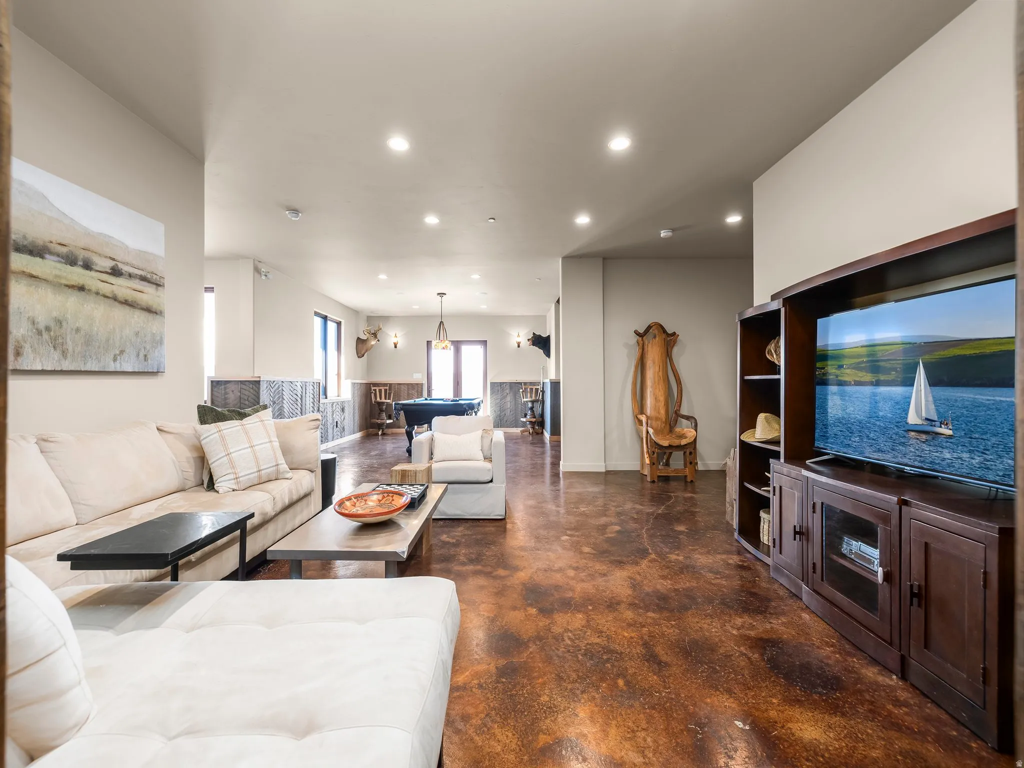 Living area featuring concrete flooring, billiards table, and recessed lighting
