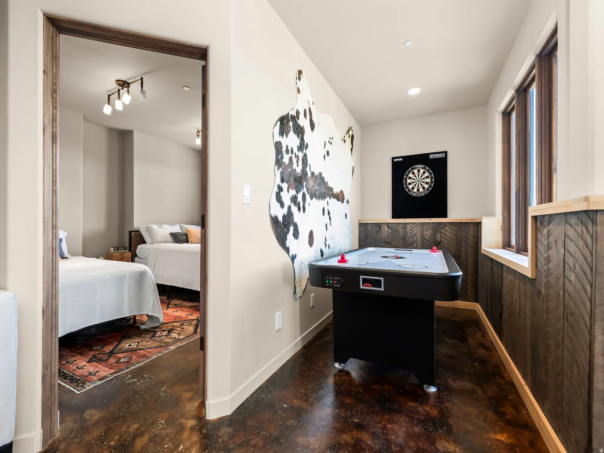 Game room featuring concrete flooring and recessed lighting