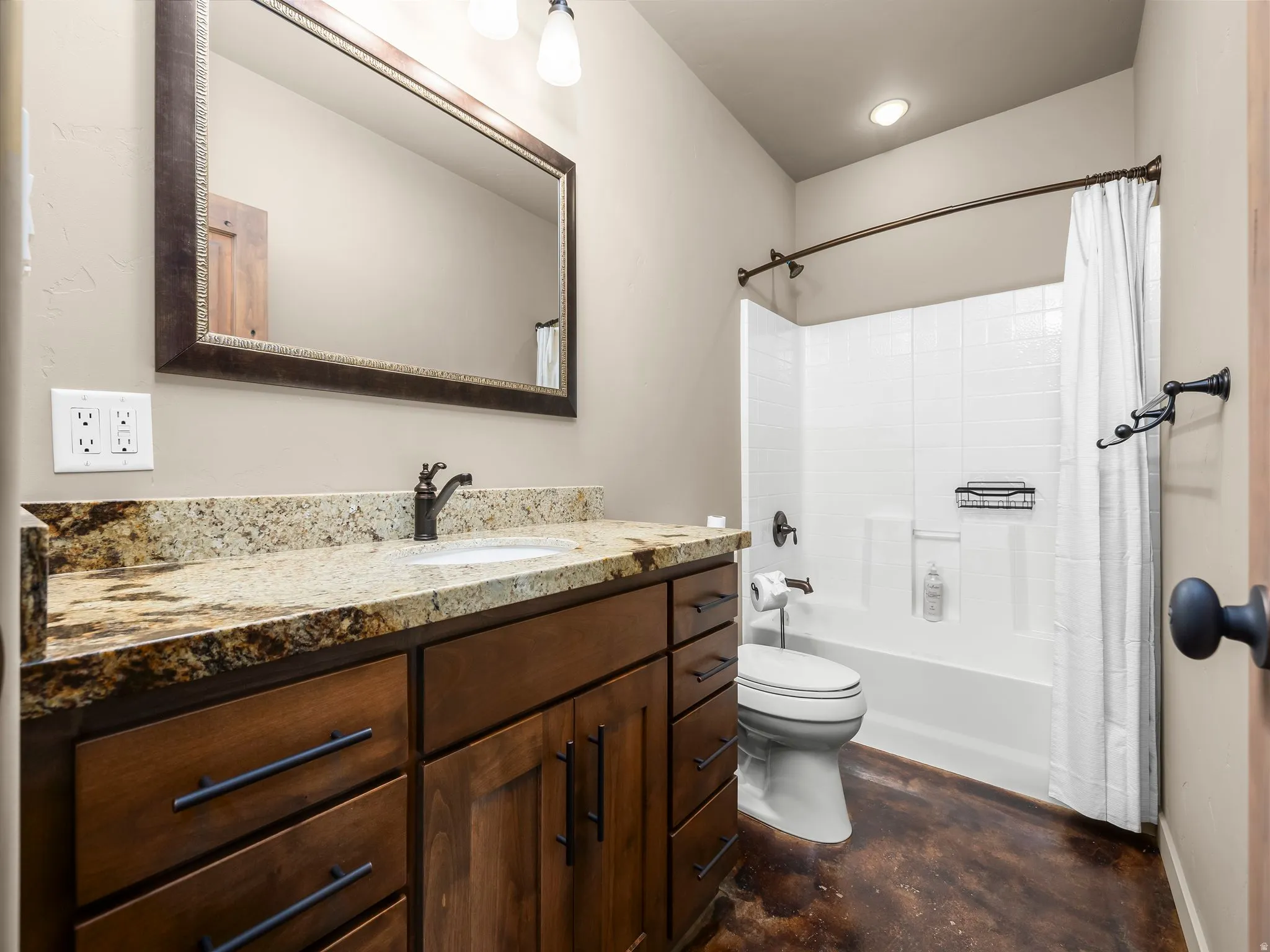 Bathroom featuring vanity, concrete flooring, and shower / tub combo with curtain
