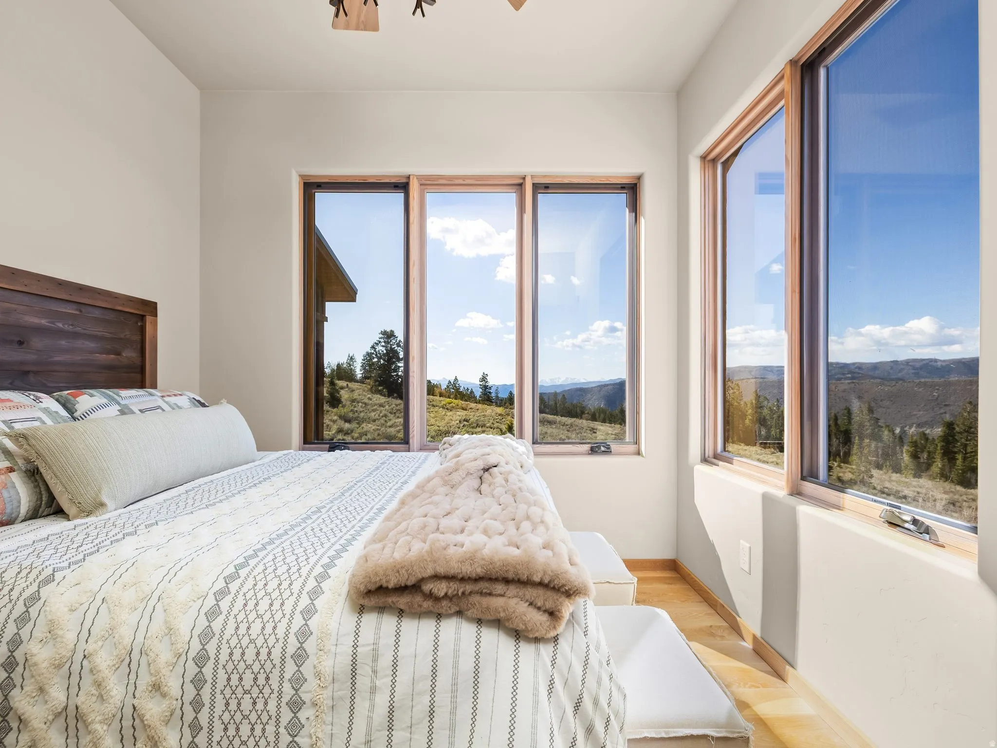 Bedroom with wood finished floors and a mountain view
