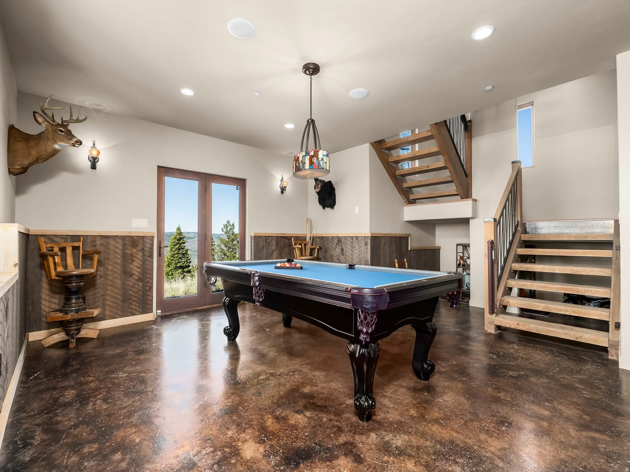 Playroom featuring finished concrete flooring, recessed lighting, billiards table, a wainscoted wall, and bar