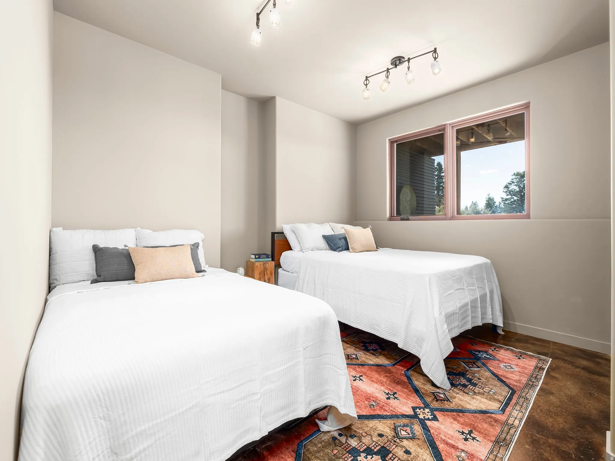 Bedroom with concrete floors and rail lighting